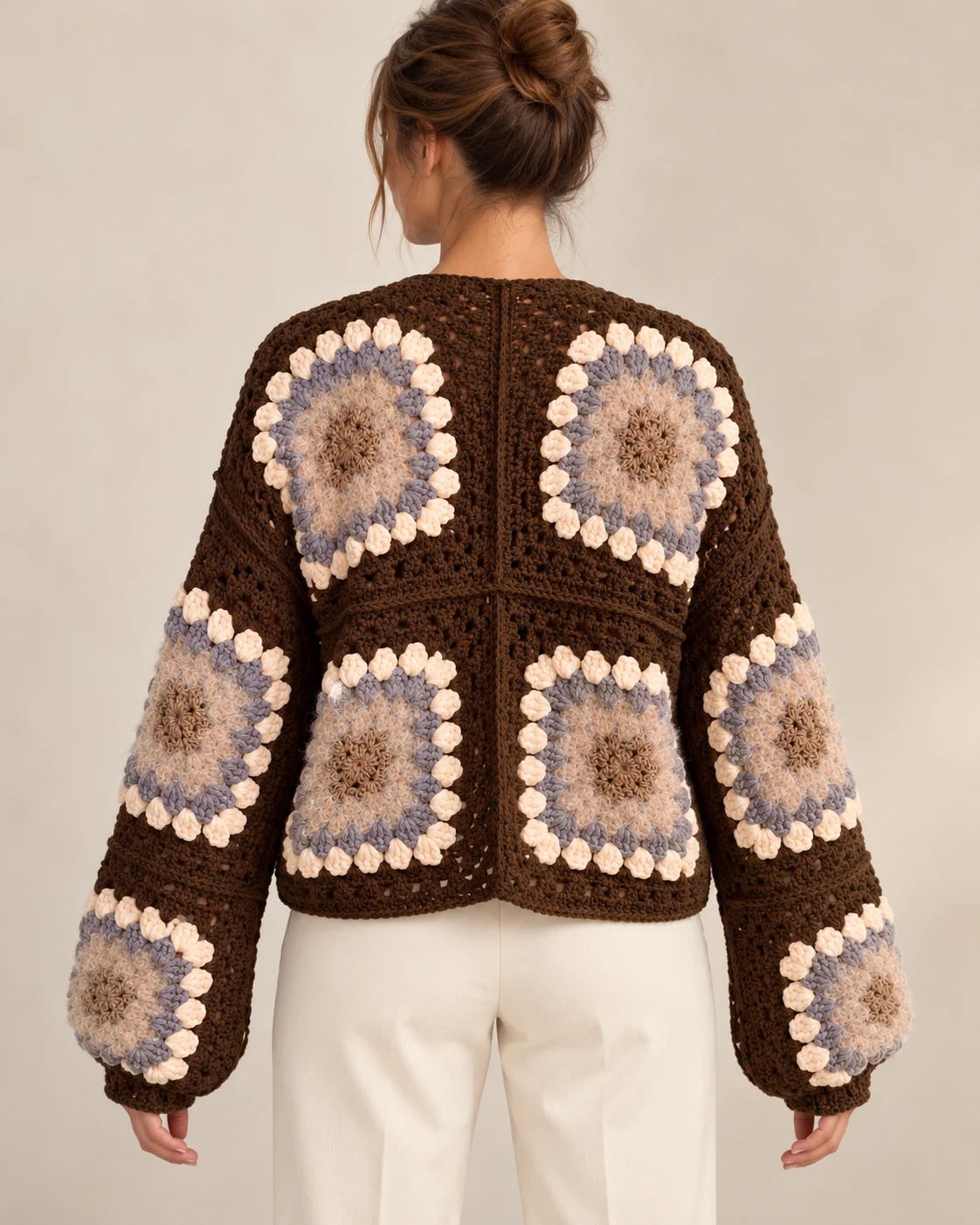 Model wearing the Cocoa Bloom crochet cardigan, back view showing floral squares and cropped length