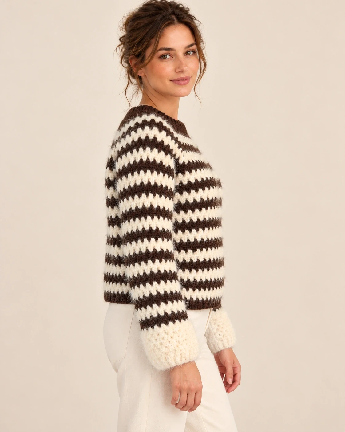 Side view of a model wearing the cocoa and cream striped cotton pullover, showing the relaxed body and long sleeves